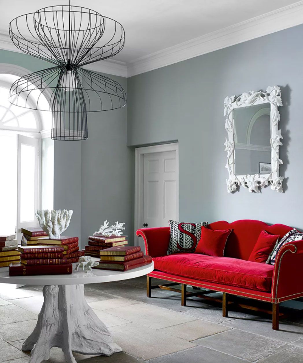 Living room with huge central light and red sofa