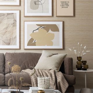 living area with brown sofa and artworks