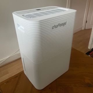 White dehumidifier on a wooden dining room table