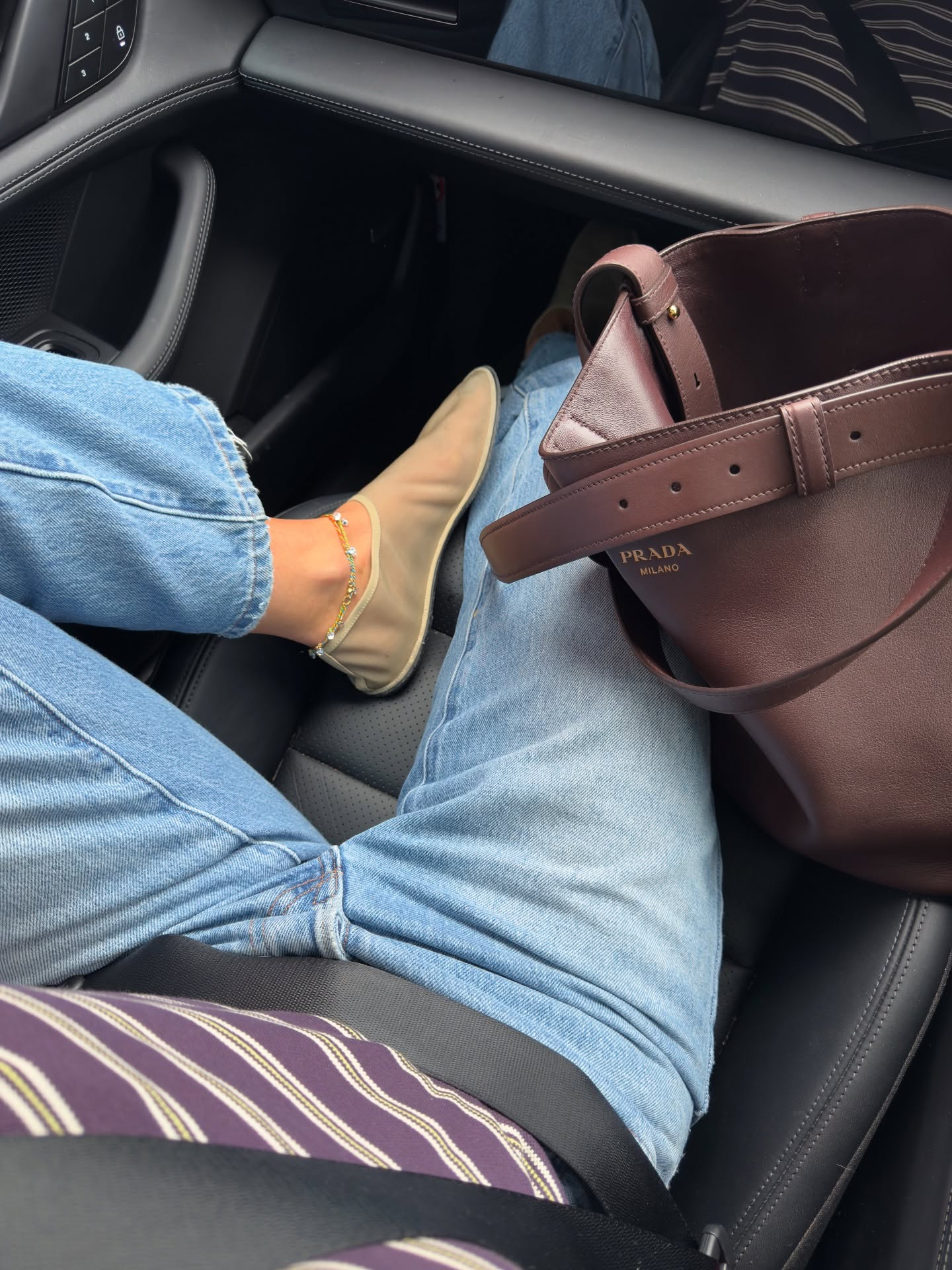 Marianne Smyth in jeans and a brown Prada bag.
