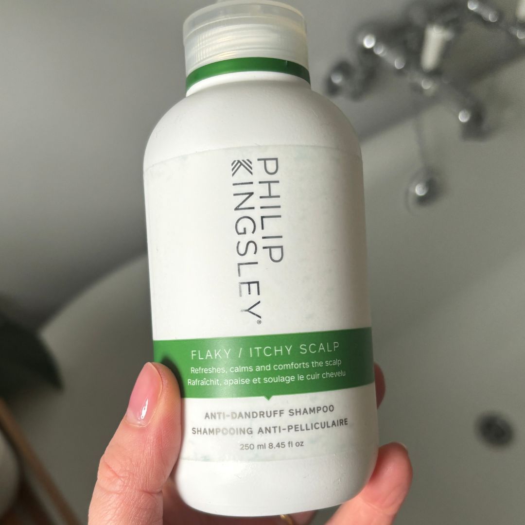 Laura holding Philip Kingsley Flaky Itchy Scalp Anti-Dandruff Shampoo