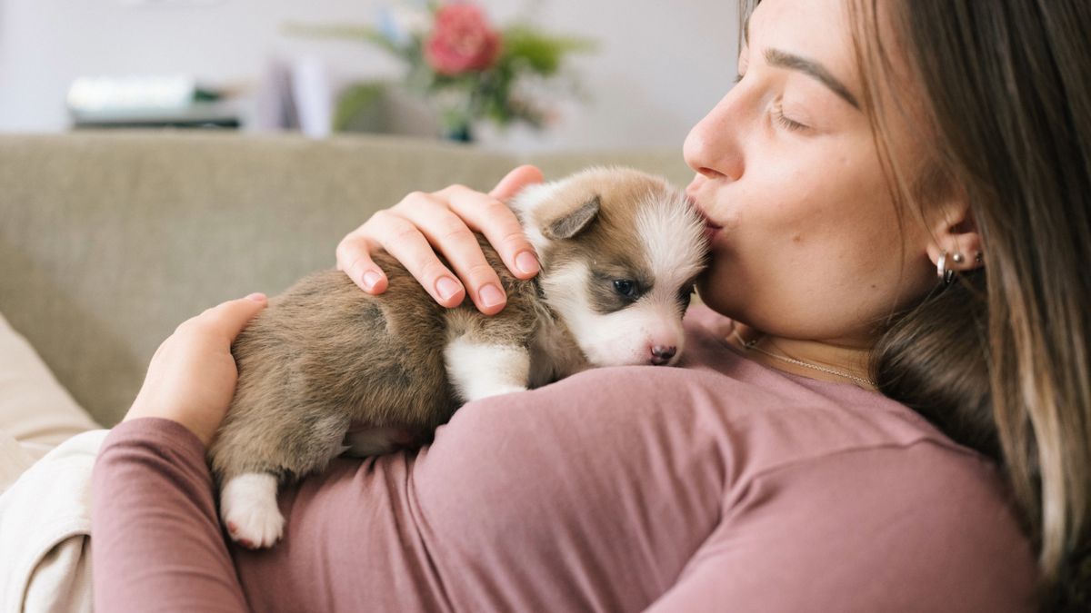 Woman cuddling puppy