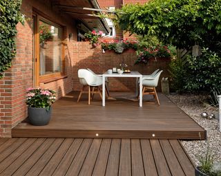 decked area with dining set and built in lights