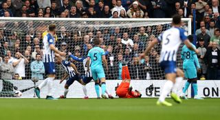 Neal Maupay, centre left, wheels away after scoring as Hugo Lloris, centre right, lies injured