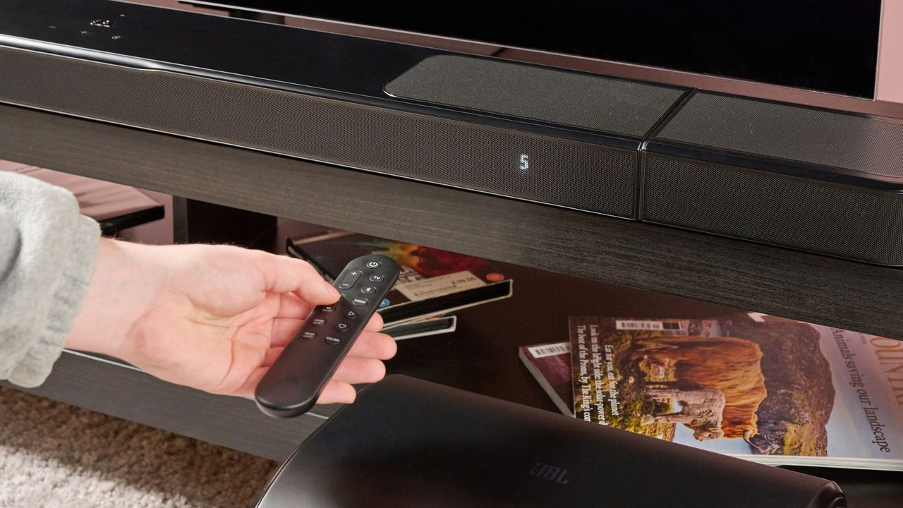 Man using remote on the JBL Bar 1300MK2