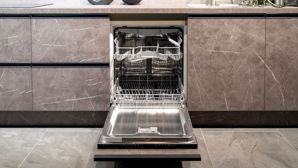 Contemporary grey marble effect kitchen units with integrated dishwasher door fully open