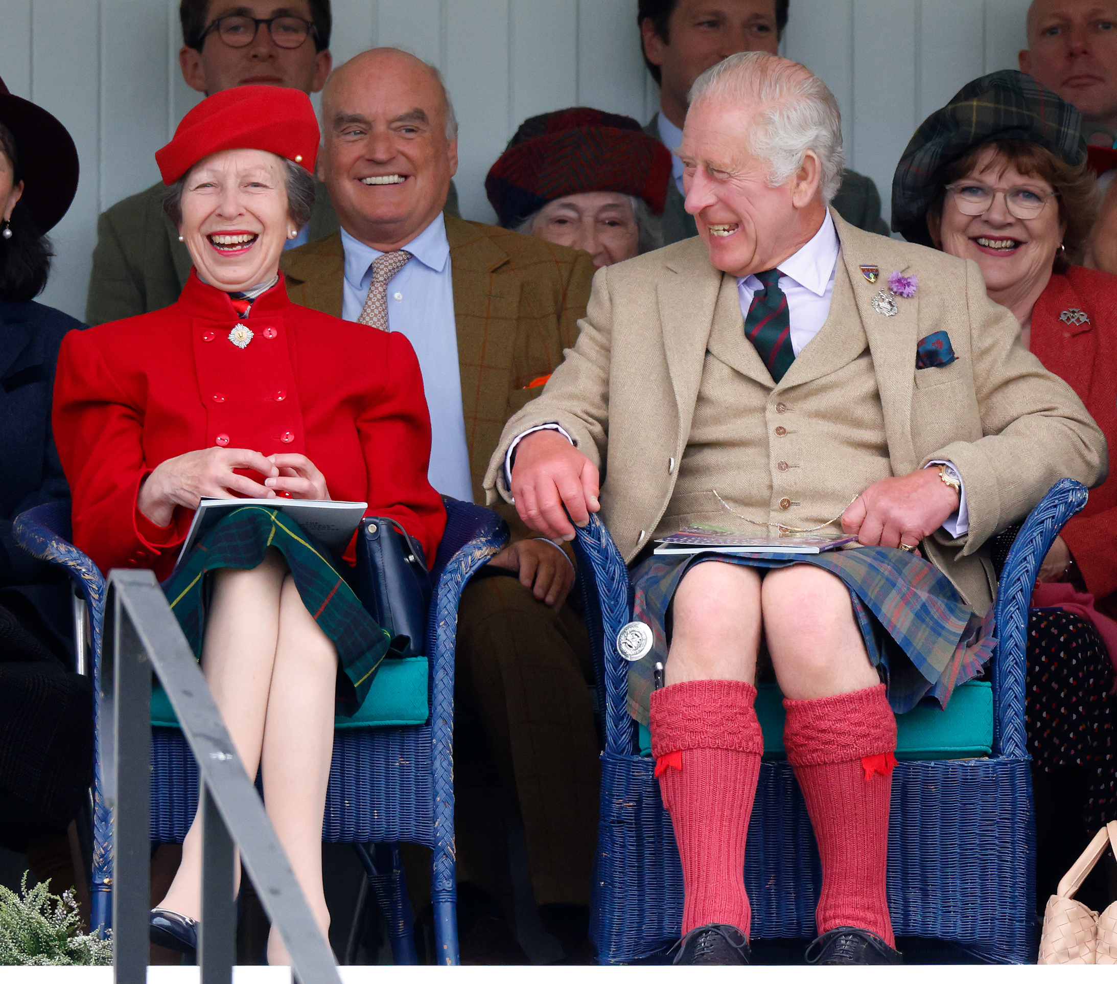 Princess Anne and King Charles sitting next to each other and laughing