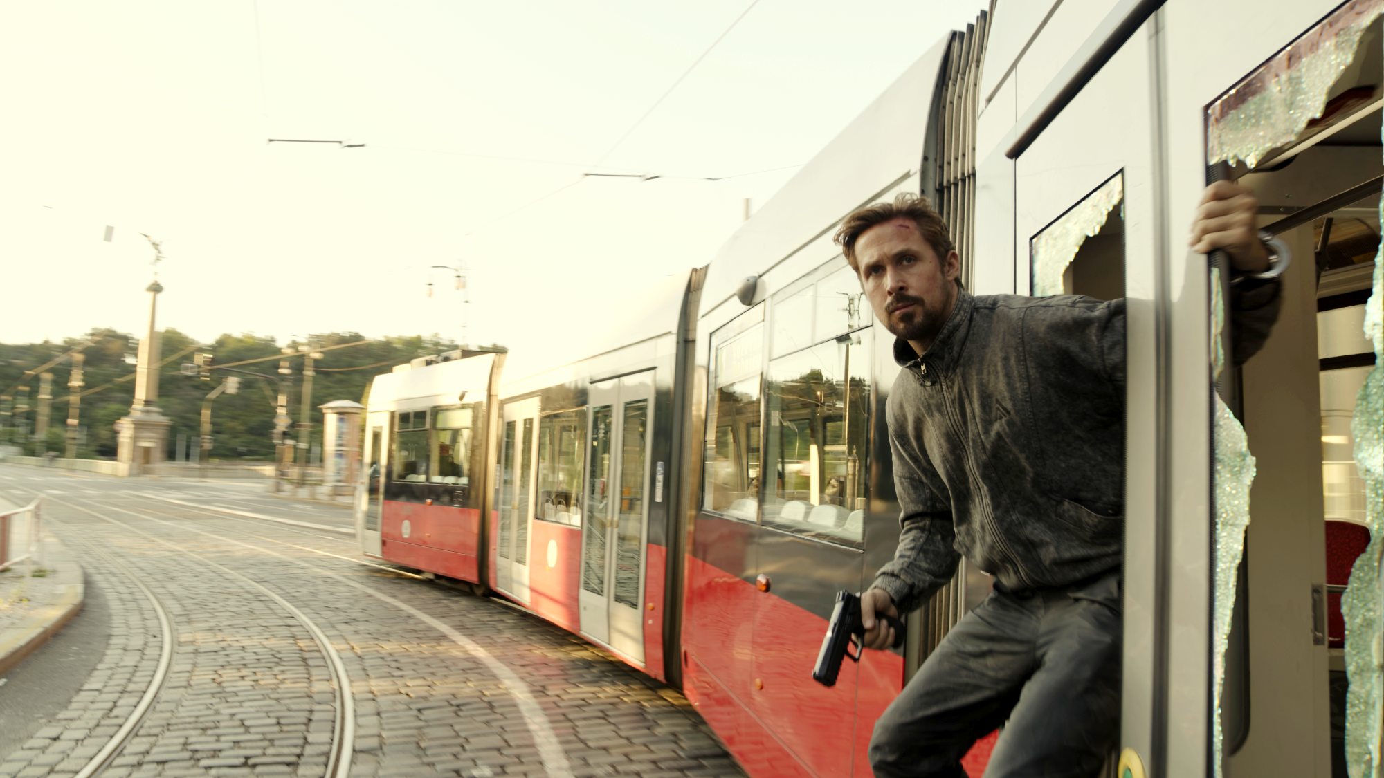 Ryan Gosling is on a train in The Gray Man