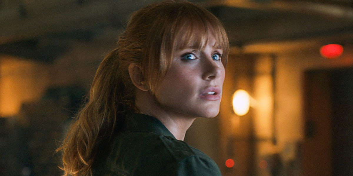 Bryce Dallas Howard looking at a dinosaur in Jurassic World