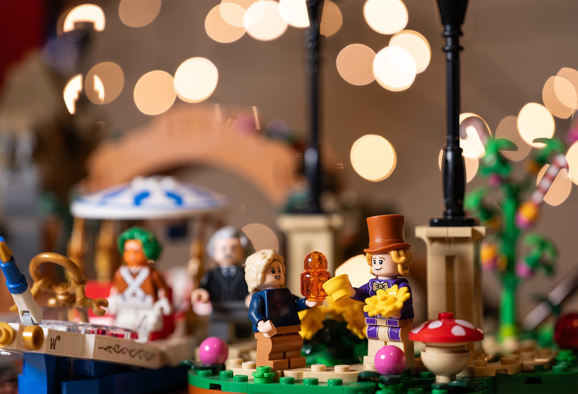 Colorful Lego Willy Wonka set with three characters and round discs of bokeh in the background