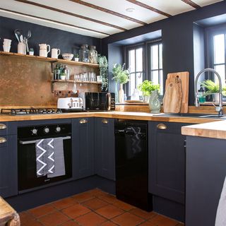 black painted kitchen with wooden worktops