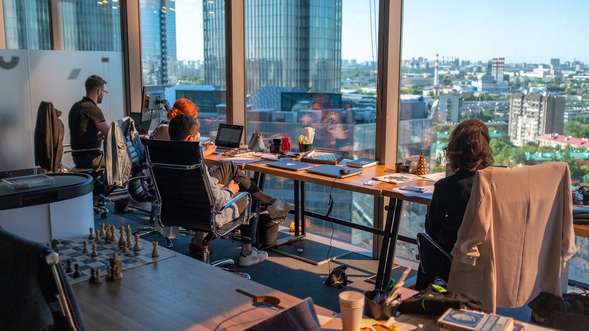 colleagues working in office with a view of a city skyline