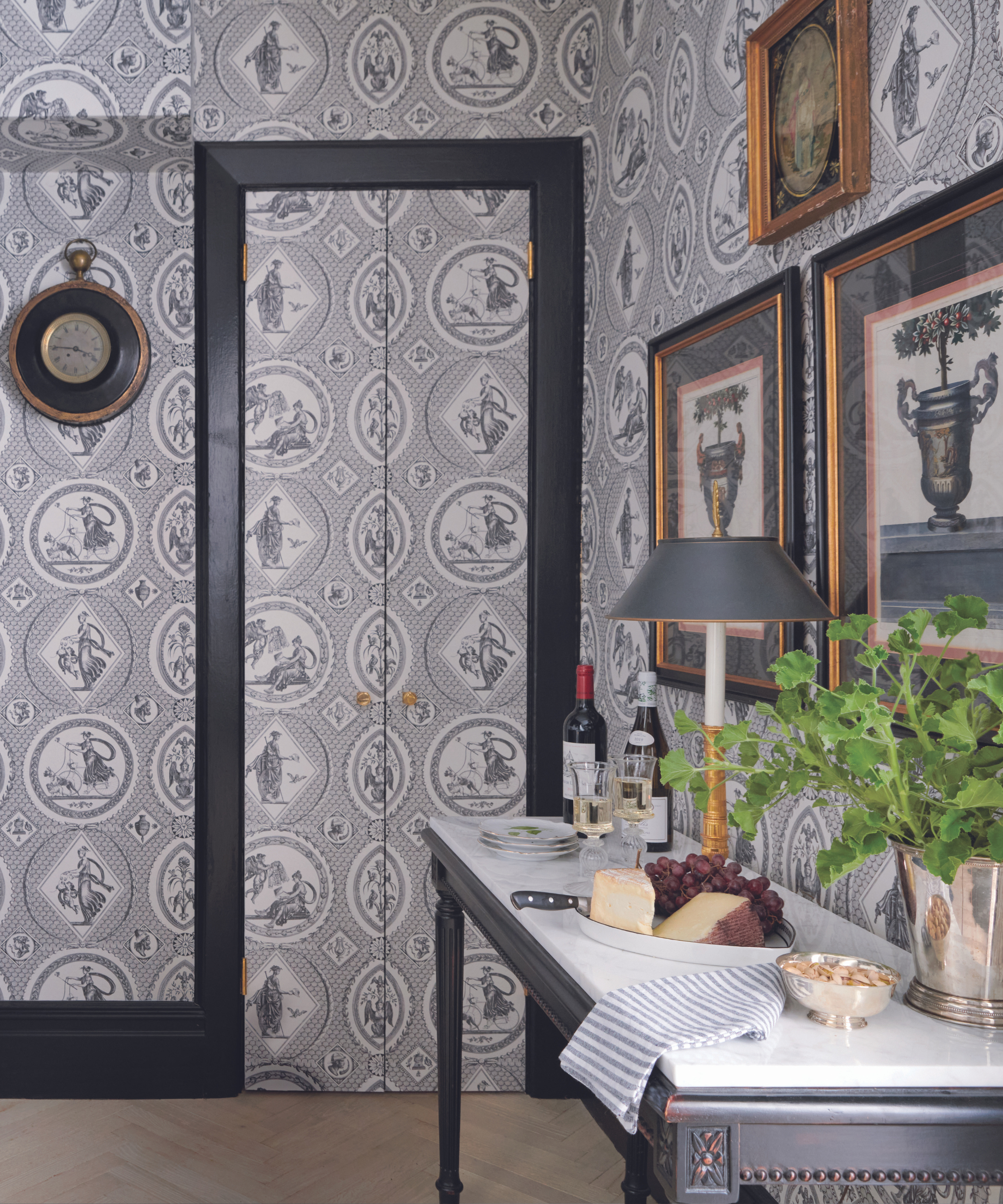 toile wallpaper in kitchen with sideboard and art on walls