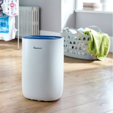 meaco dehumidifier in laundry room with basket of clothes