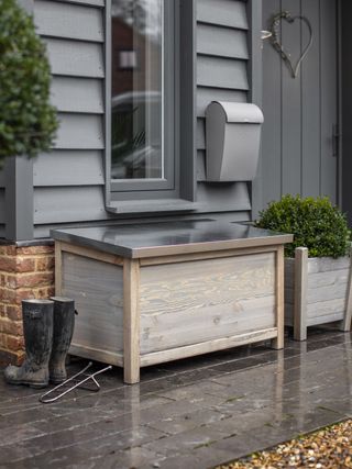 Outdoor storage boxes Garden Trading storage box with a pair of wellies
