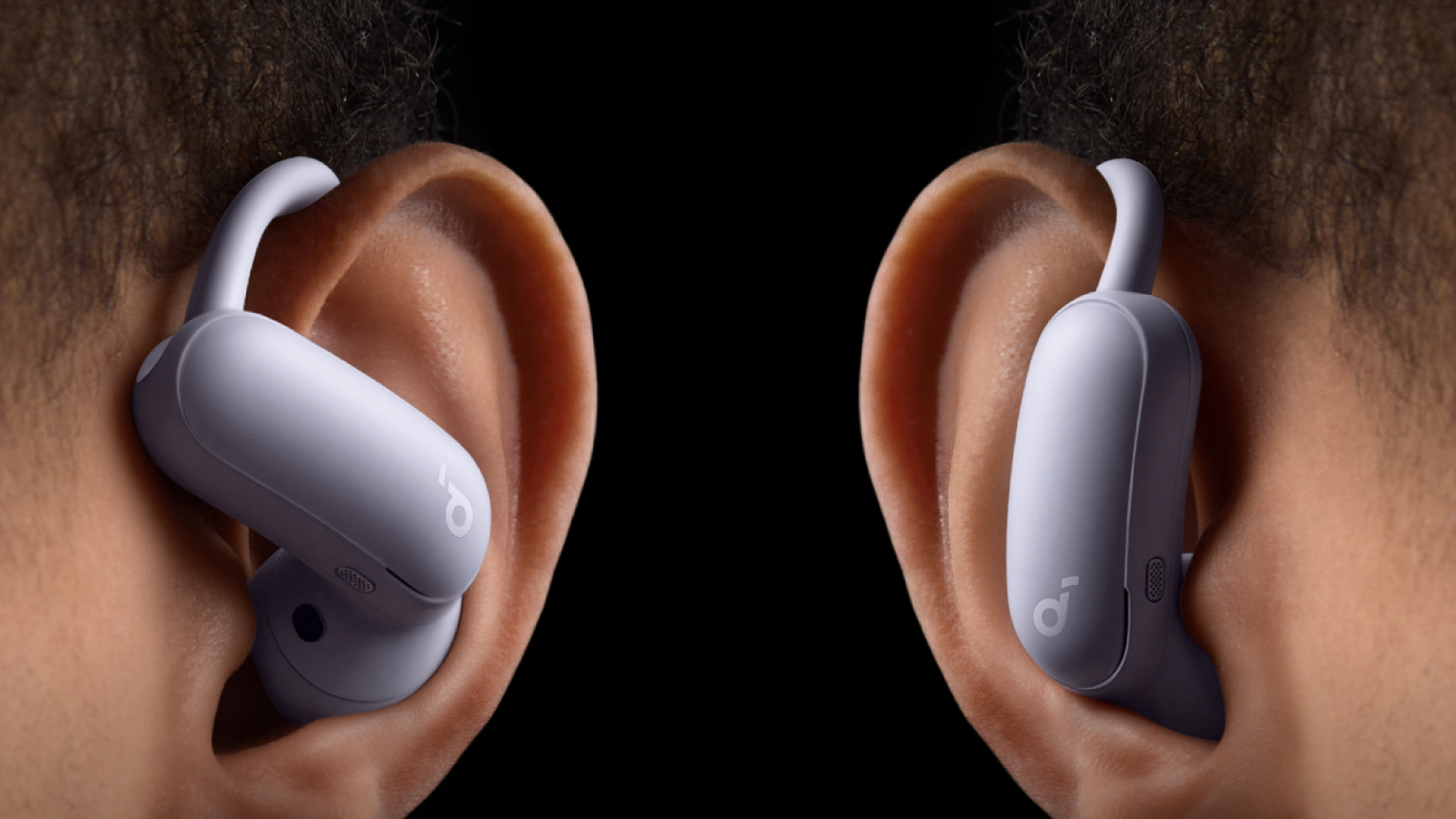 Close-up of two ears showing the two different fits of the Soundcore AeroFit 2 Pro earbuds