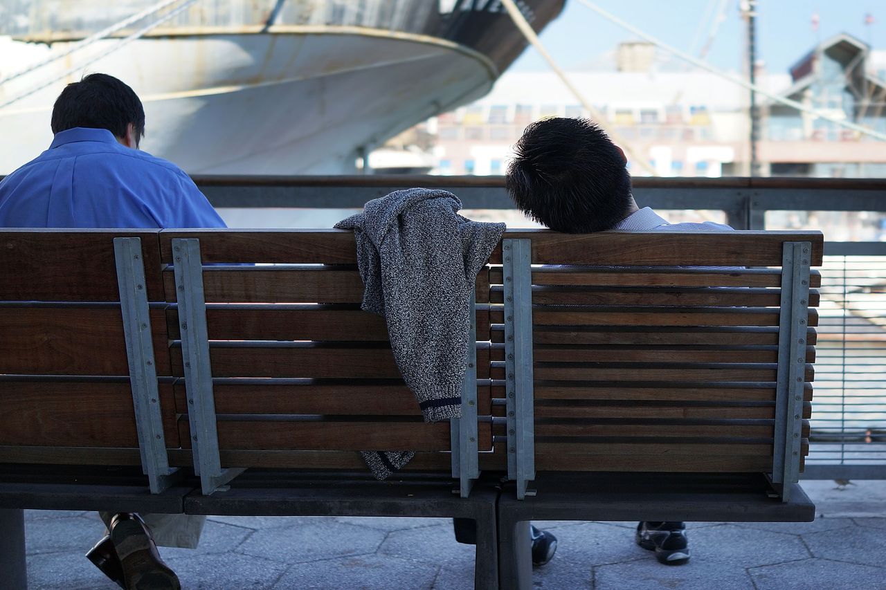 Man napping on bench.