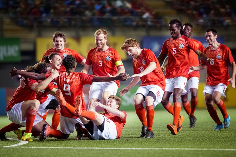 Football players celebrating a goal