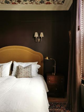 Brown bedroom with ochre headboard