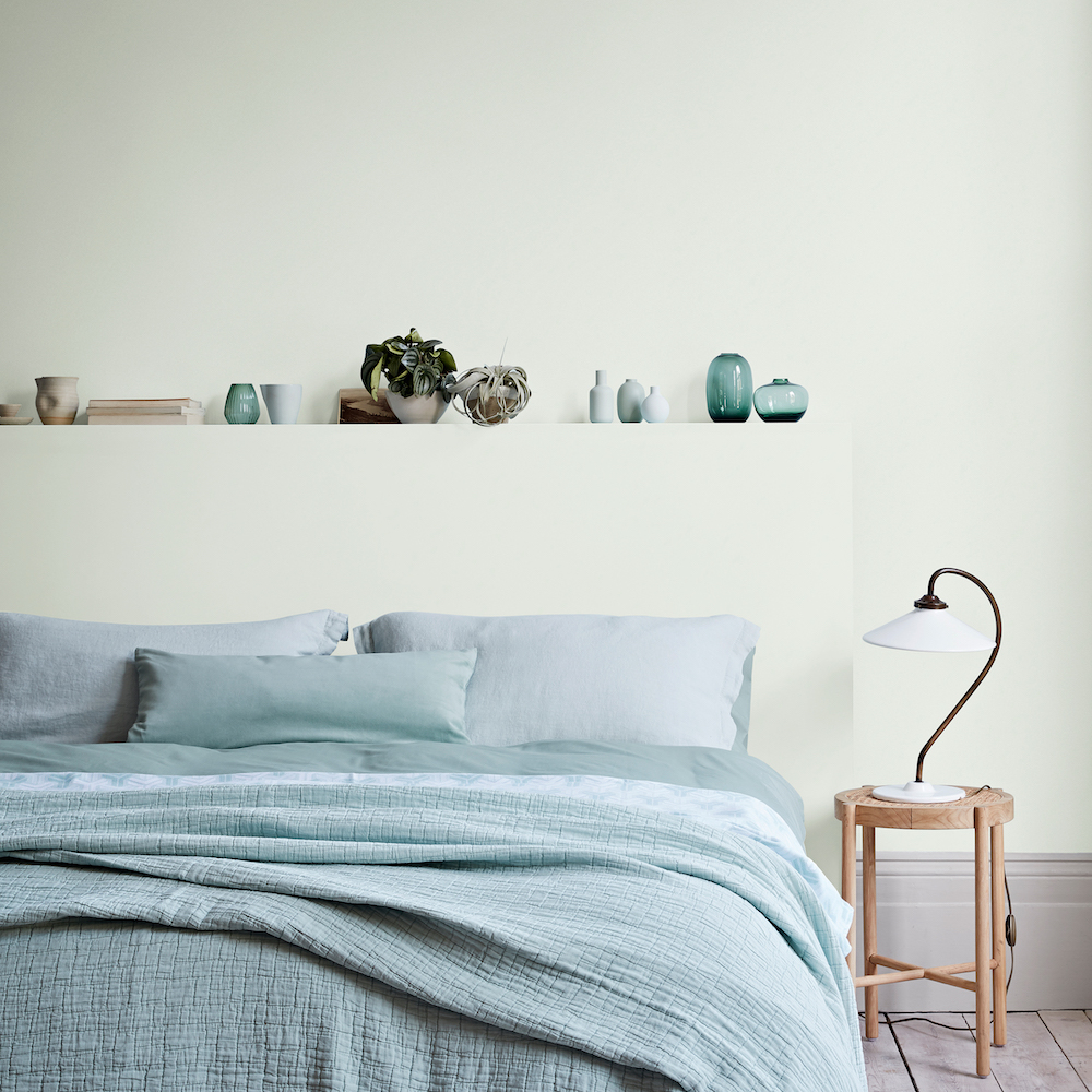 bedroom with wooden stool and white lamp