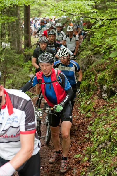 Riders walk in a long line of traffic