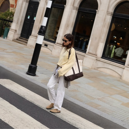 Alice in jumper, white jeans and Birkenstocks