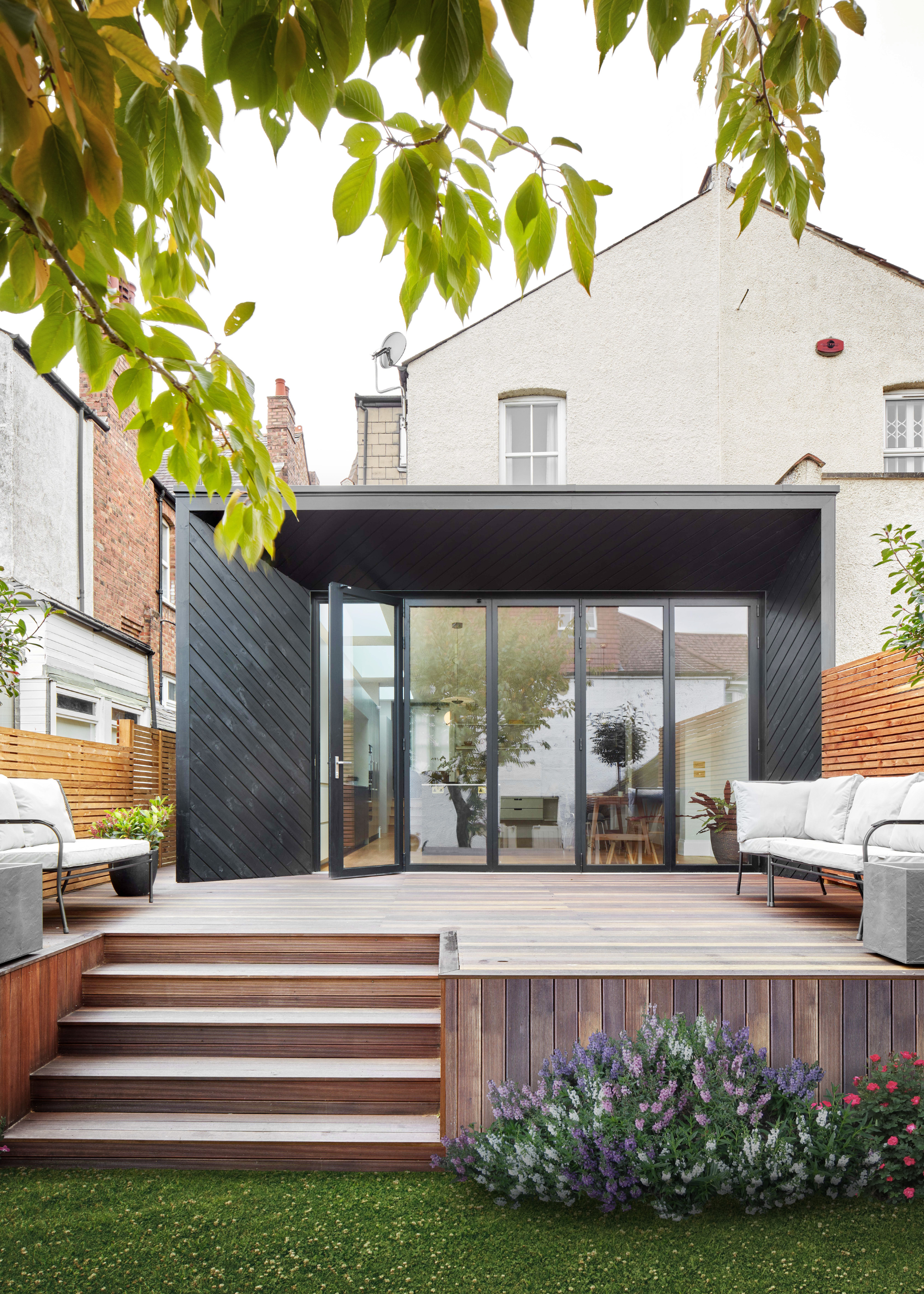Terracotta pots lining garden steps as well as wooden decking