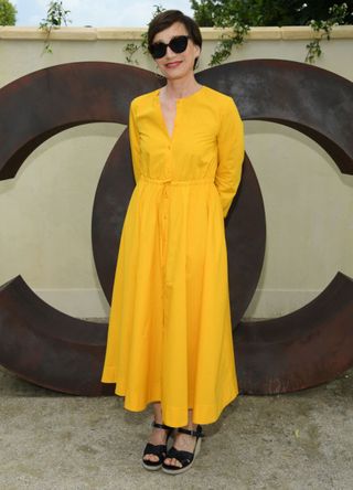 Kristin Scott Thomas poses at a photocall prior the Chanel Opening Party for the Exhibition "Dans les Champs de Chanel" at Jardin des Tuileries on May 30, 2018 in Paris, France