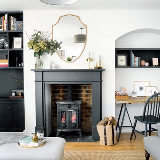 White living room with wood burner in exposed brick fireplace