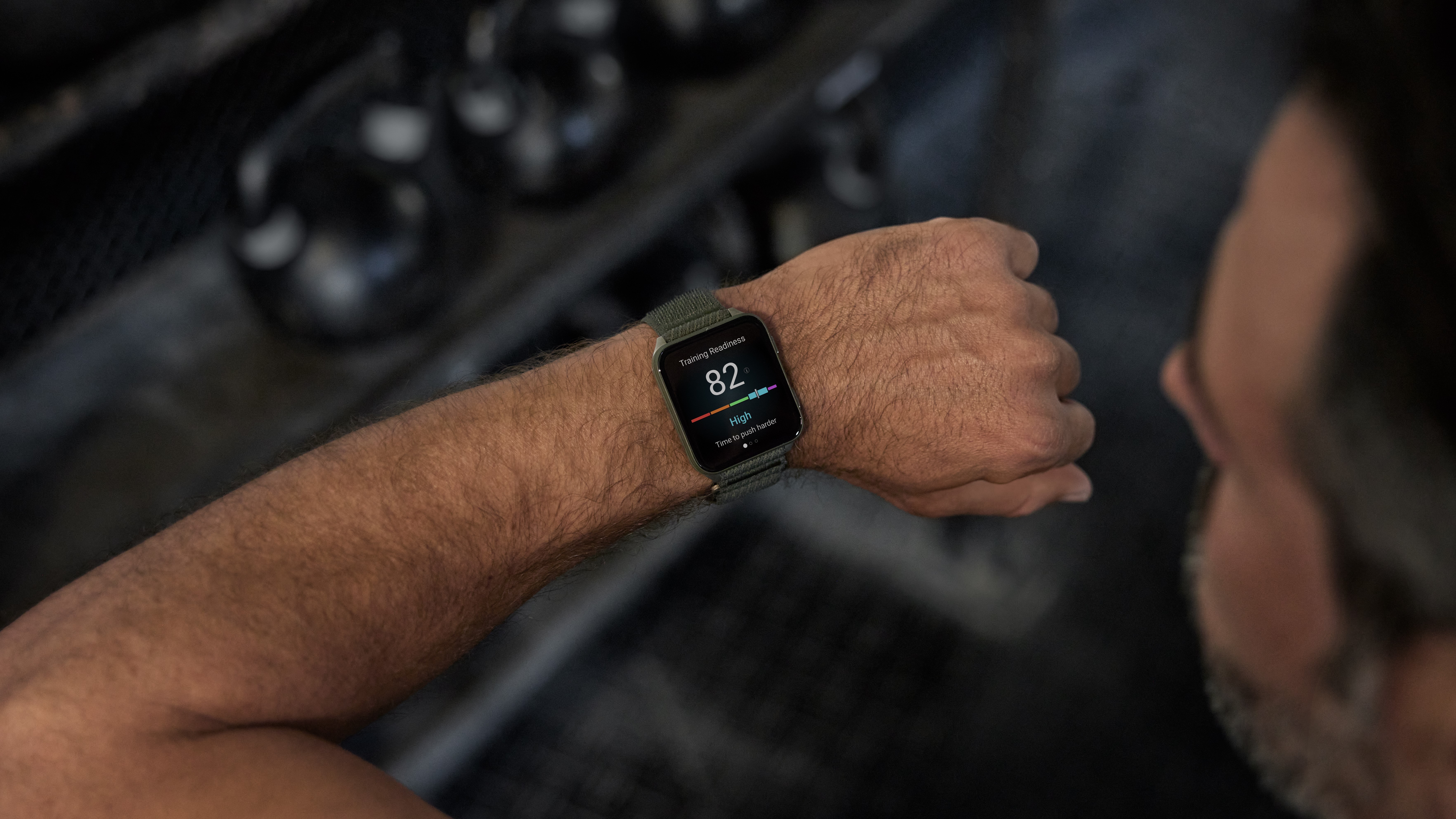 Photo of the Garmin Venu X1 on an athlete's wrist showing his daily readiness score (High)