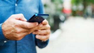 Close up of man using an iPhone