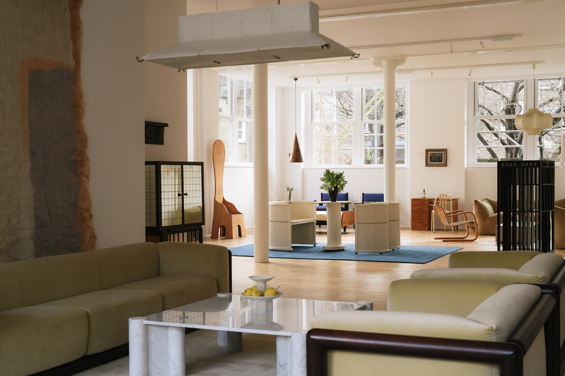Image of the Spazio Leone gallery in London. It's a bright showroom with multiple seating areas arranged to display the different furniture on show.
