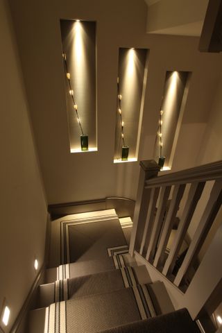 staircase with staircase lighting and recess lighting