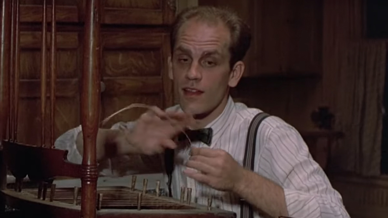 John Malkovich wearing a tie and suspenders in A Place In The Heart