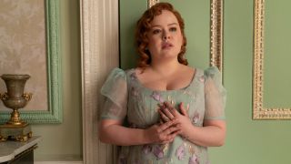 Nicola Coughlan as Penelope Featherington holding the ring on her left ring finger.