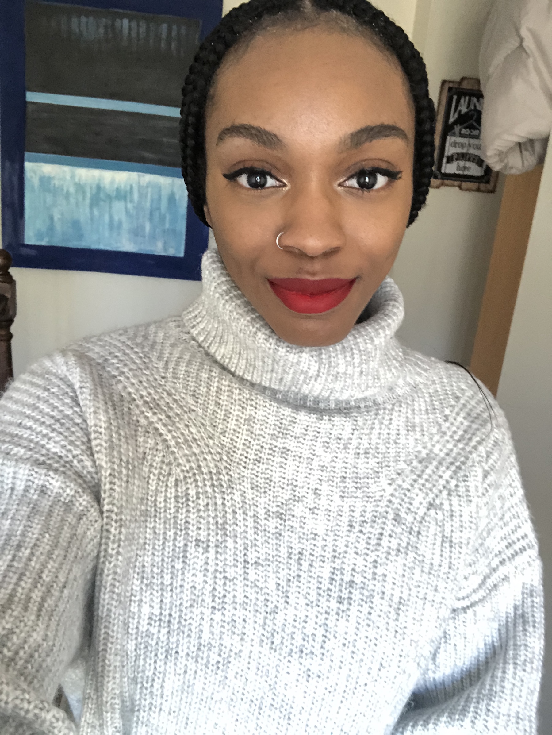 a black woman with dark hair wearing red lipstick and black eyeliner