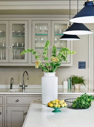 green kitchen cabinets with white countertops