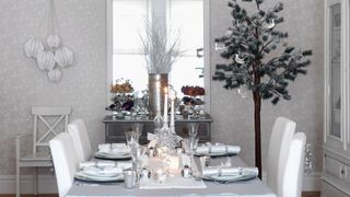 Silver glitter dining table and christmas tree to celebrate the Silver Christmas party theme