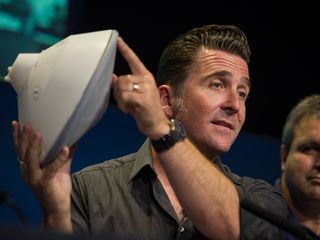 Adam Steltzner, NASA's Mars Science Laboratory entry, descent and landing phase lead, holds a model of the spacecraft.