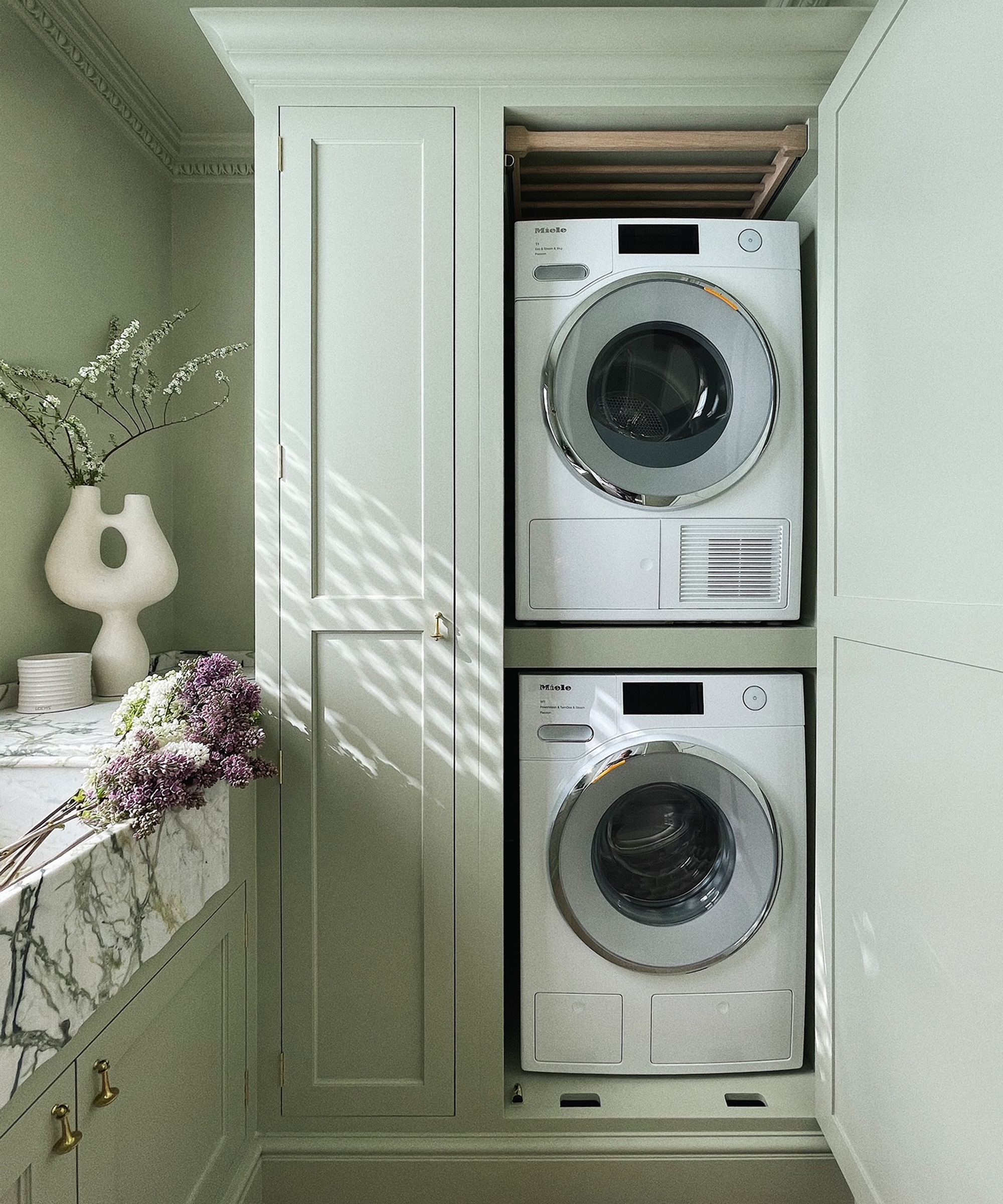 small utility room with stacked appliances