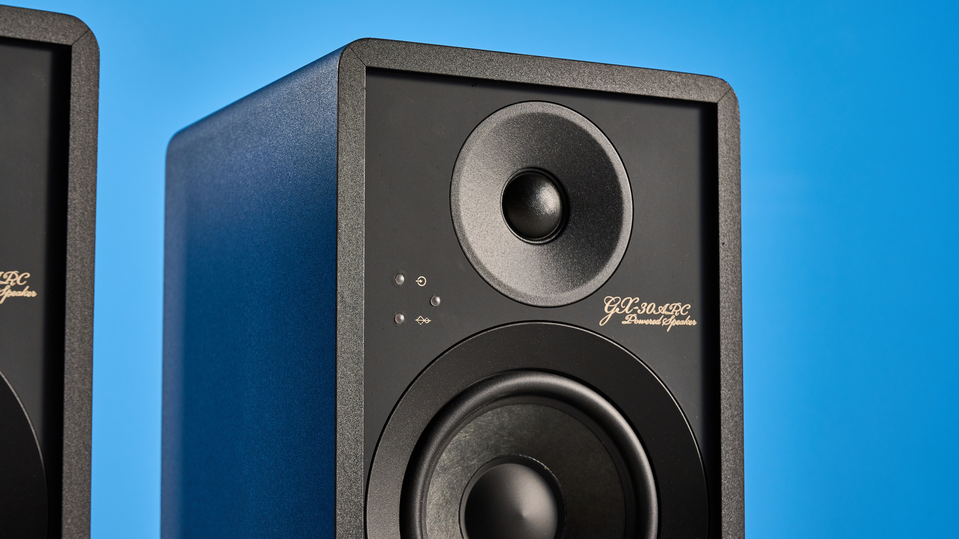 Onkyo GX-30ARC bookshelf speakers photographed on a blue background