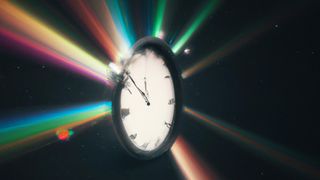 A pocket watch shoots out diffracted light against a black background.