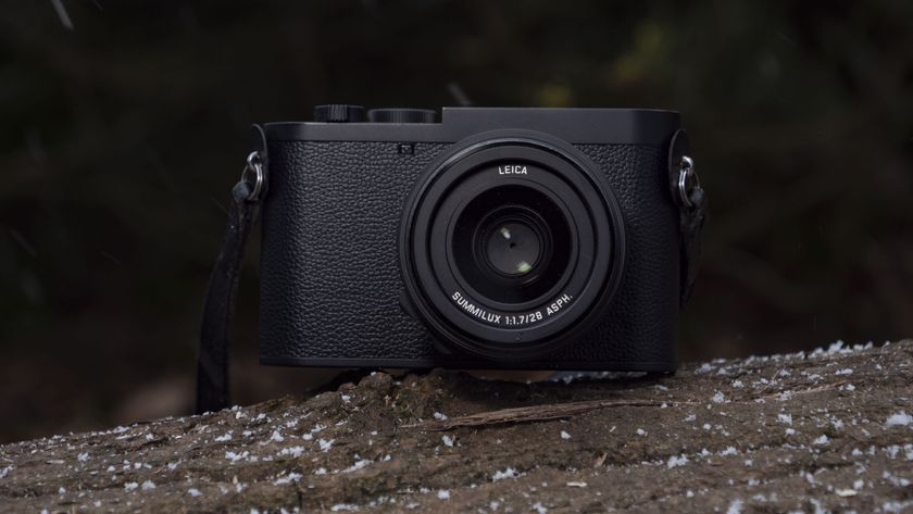 Leica Q3 Monochrom compact camera outside on a snow-dusted log