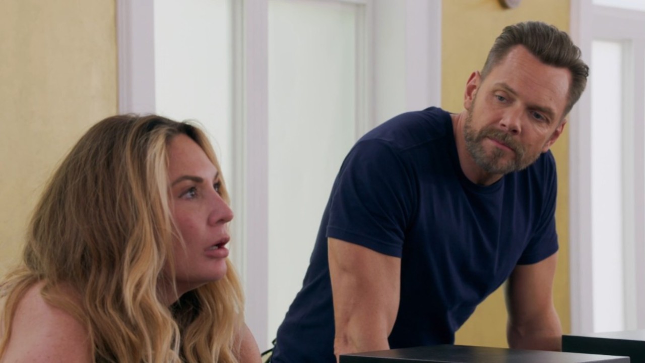 Joel McHale looking at Kate Chastain in House of Villains.