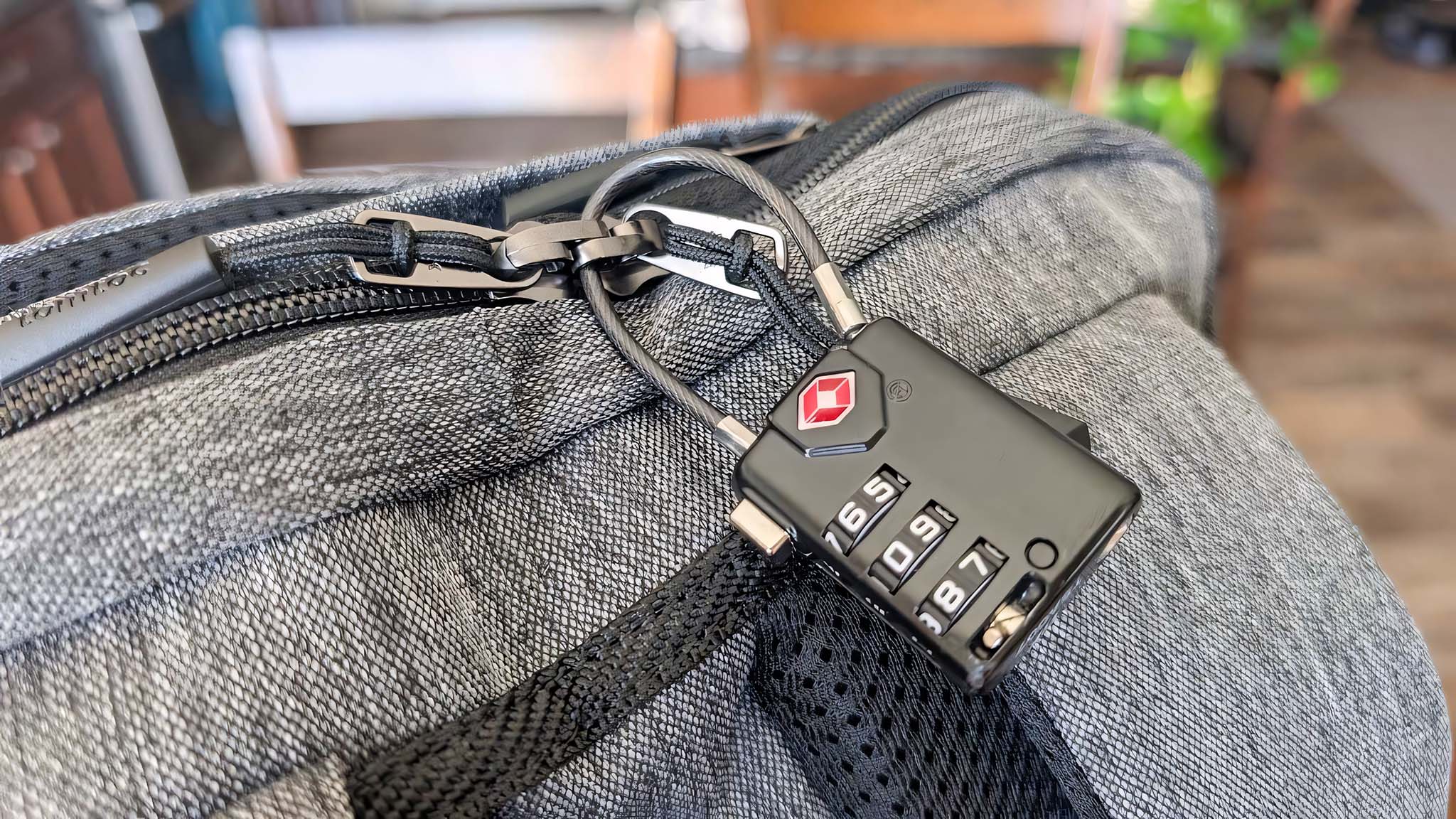 Closeup of the main Tomtoc Navigator-T66 zippers with a TSA lock.