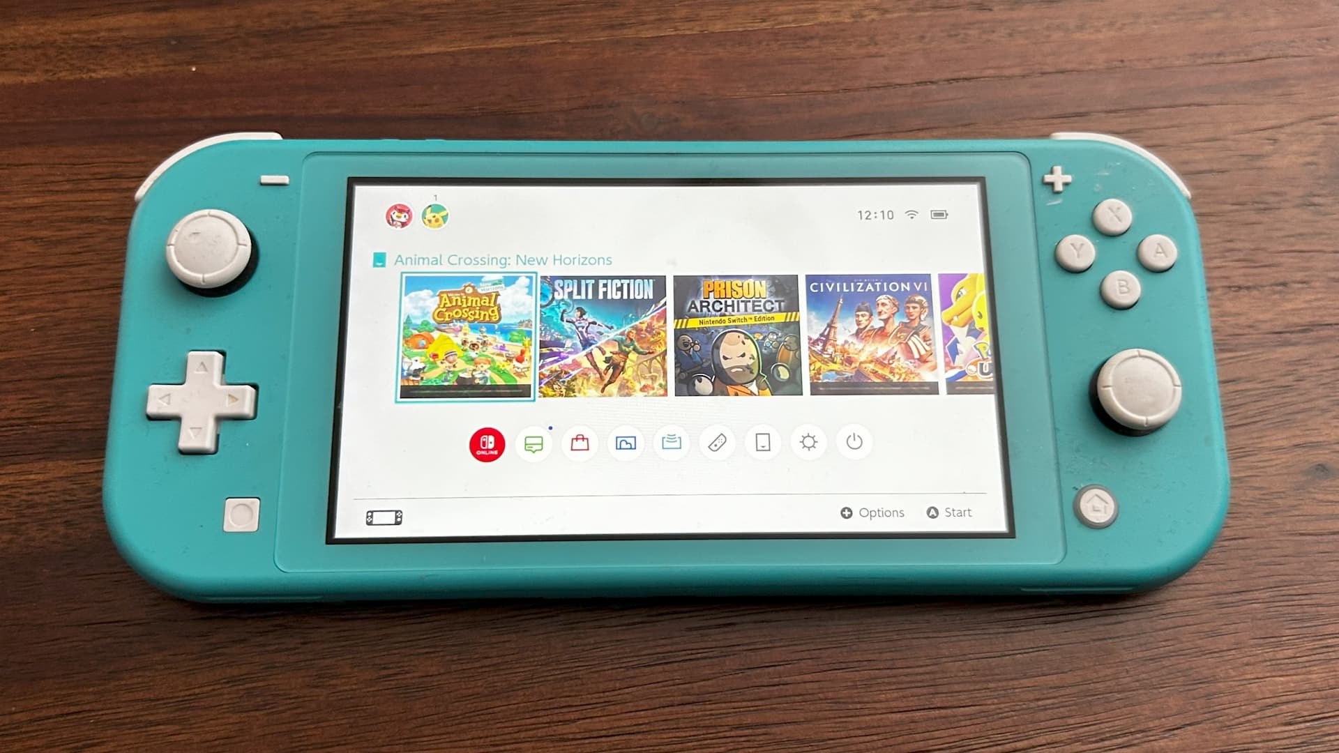 A blue Nintendo Switch Lite on top of a brown table