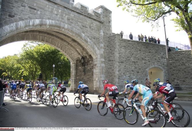 Riders go under a bridge