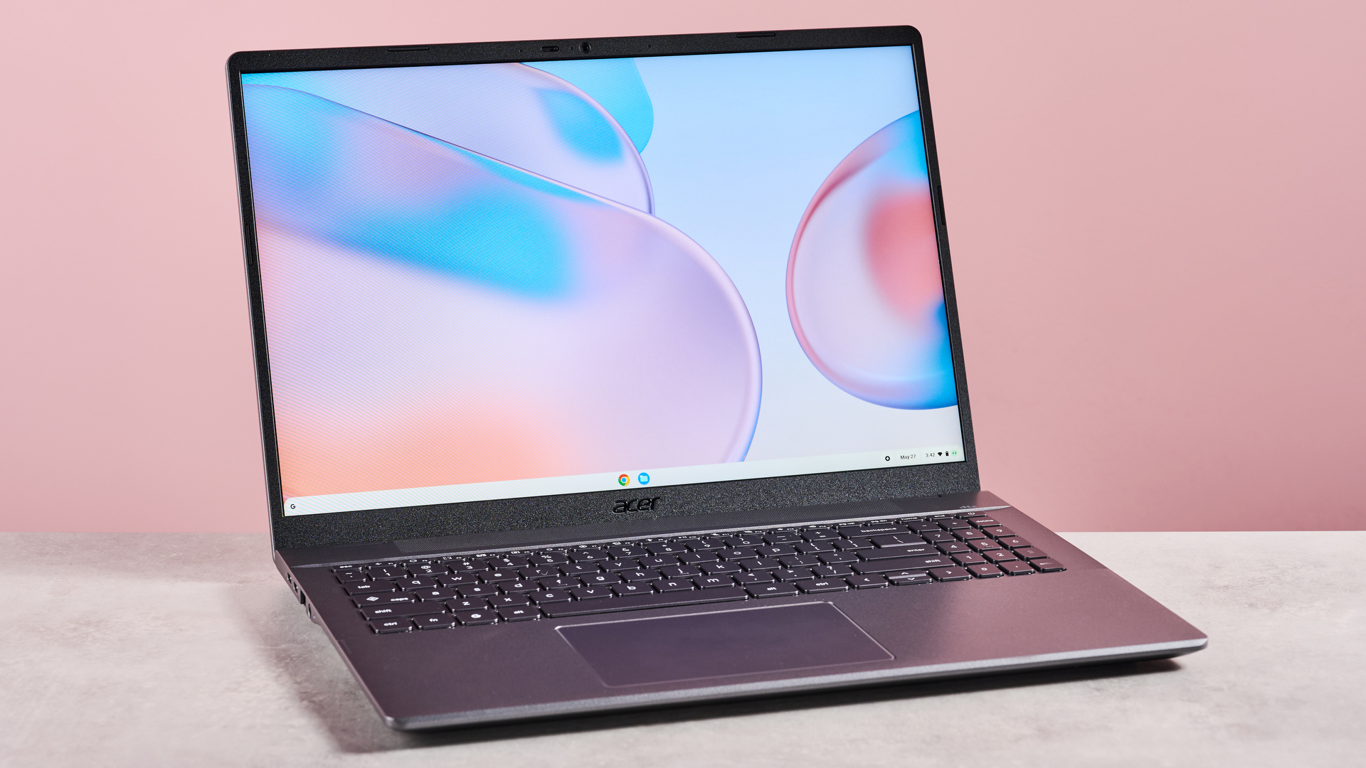 Acer Chromebook Plus 514 open on desk with pink background