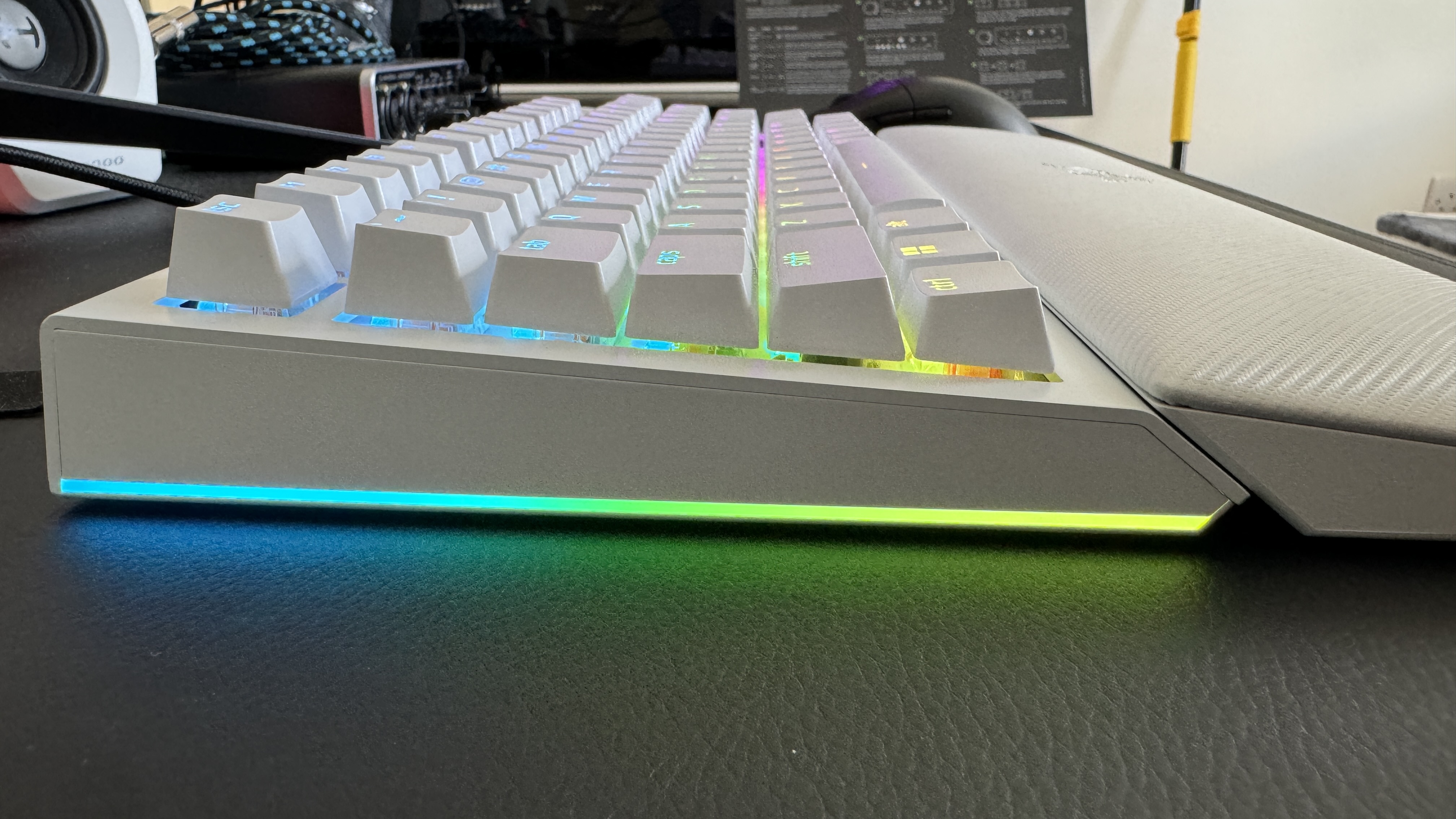 Razer BlackWidow V4 75% gaming keyboard set-up on a desk with RGB enabled.