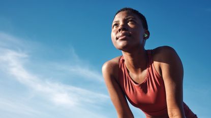 A woman running in the heat against a blue sky